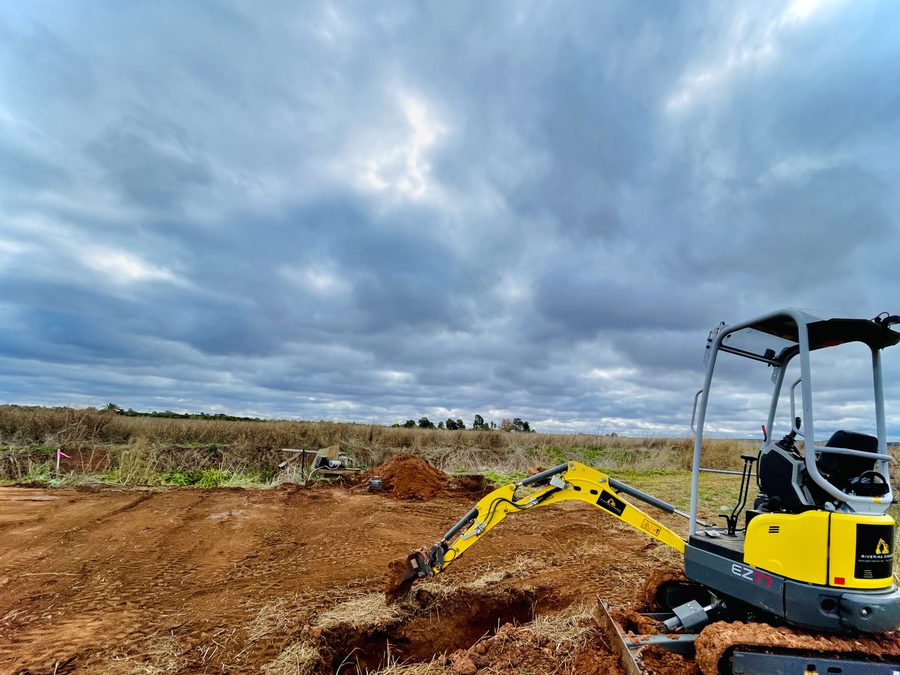 Riverina Diggers mini excavator on a levelled pad with spoil heaped alongside, Griffith NSW